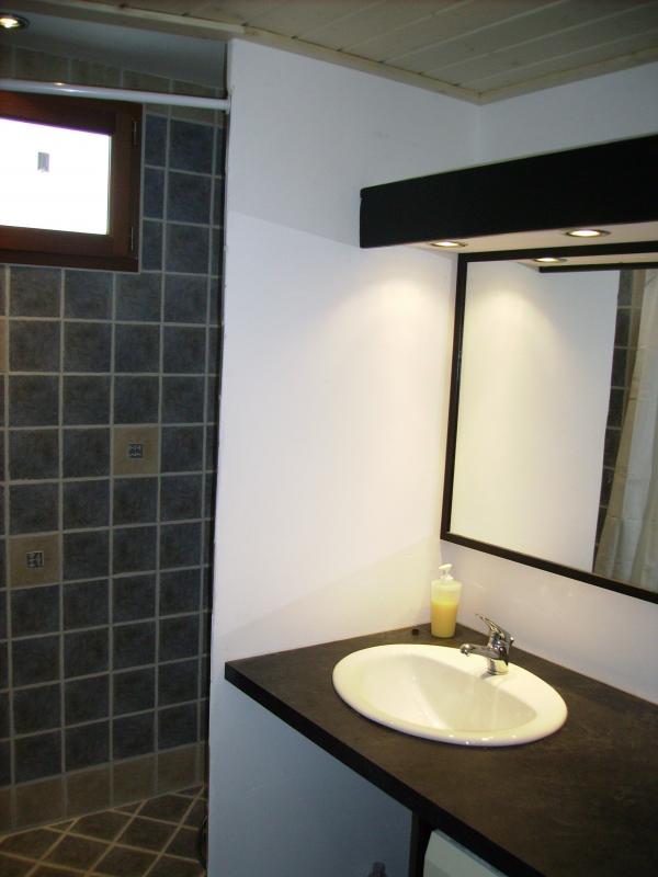 Salle de bain avec douche &agrave; l'italienne, vasque encastr&eacute;e et radiateur &eacute;lectrique porte serviette